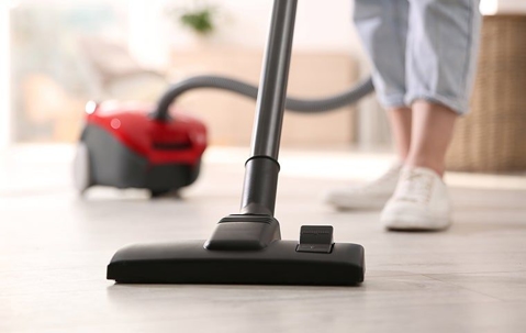 a woman vacuuming a house