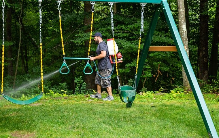 technician spraying for mosquitoes outside